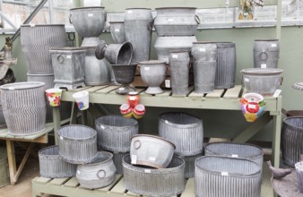 Display of metal planting containers, The Walled garden plant nursery, Benhall, Suffolk, England,