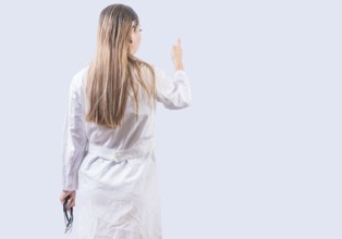 Rear view of female doctor pointing isolated. Young female doctor from behind pointing finger