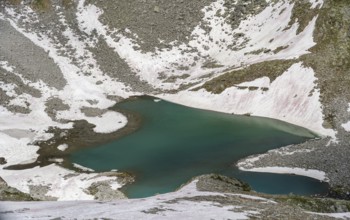 Mountain landscape with snow and blue lake Friesenbergsee, Berliner Höhenweg, Zillertal Alps,