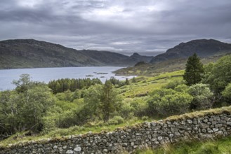 Old dry stone wall and Loch Glencoul near Unapool and Gleann Dubh, Kylesku, Sutherland in the