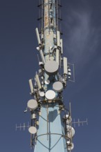 Mobile phone communications tower with antennas against blue sky, Mount Srd, Dubrovnik, Croatia,