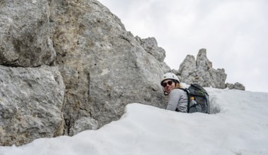 Mountaineer making her way through high snow, Wilder Kaiser, Kaiser Mountains, Tyrol, Austria,