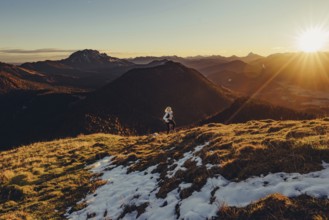 Trail running in autumn on the Jochberg on Lake Walchensee against the wonderful backdrop of the