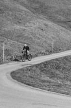 Road bike rider in spring in the Allgäu against the picturesque backdrop of the Alps, Bavaria,