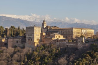 Alhambra on the Sabikah hill, Moorish city castle, Nasrid palaces, behind the snow-covered Sierra