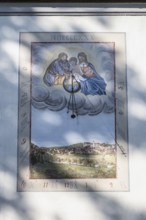 A sundial on the parish church of St. Nicholas in the centre of Scheer, Danube Valley, Sigmaringen