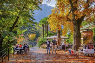 Winter promenade on the River Passer with street café in autumn, Merano, Burggrafenamt, Adige