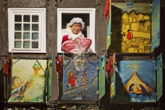 Mrs Holle shakes out her pillow of gold coins at the large Advent calendar at the Old Town Hall,