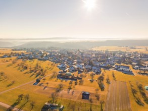 Aerial view of a village in an autumn landscape at sunrise, Neubulach, Black Forest, Germany,