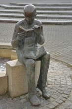 Sculpture Book reader at the fountain in front of the town library, reader, literature, books,