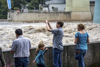 Weir of the Lake Baldeney in Essen, the masses of water roar through the open weirs, spectators,