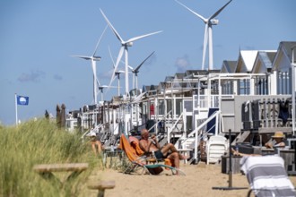 Wind turbines, wind farm, holiday homes, beach houses on the beach of Ijmuiden in North Holland,