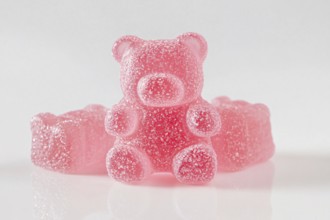 Cute opink jelly bear fruit gum candies with sugar on white background. Generative Ai, AI generated