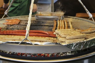 Sausages and steaks on the swing grill