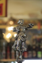 Antique beer pump metal female figure, inside famous historic Los Gatos Cervecerias bar, Madrid,