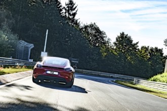 View from perspective of racing driver on sports car Porsche Cayman driving on Nürburgring race