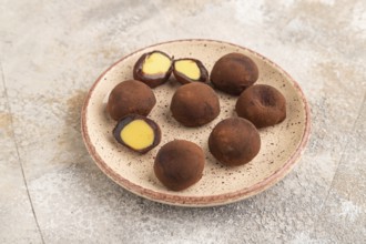 Japanese rice sweet buns chocolate mochi filled with cream on brown concrete background. side view