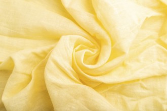 Fragment of yellow linen tissue. Top view, flat lay, natural textile background and texture. wave