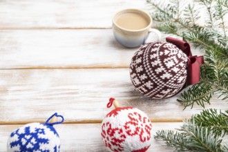 Christmas or New Year composition. Decorations, knitted balls, fir and spruce branches, cup of