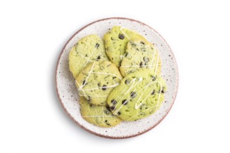 Green cookies with chocolate and mint on ceramic plate isolated on white background. top view, flat