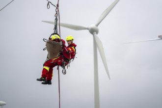 Height rescuers from the Oberhausen professional fire brigade practise abseiling from a wind