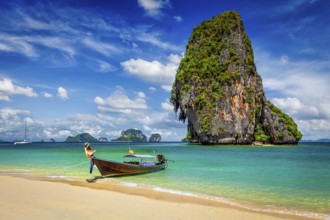 Thailand tropical vacation concept background, Long tail boat on tropical beach with limestone