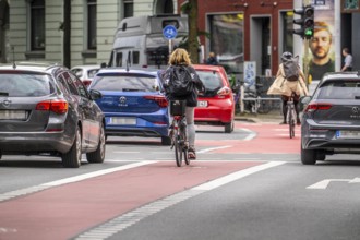 Bicycle lane, marked red, between 2 lanes for vehicles, city centre traffic, Dortmund, North