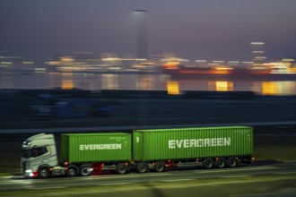 Lorry on the road to Euromax Terminal Rotterdam, ENECO wind farm on the dike around the port of