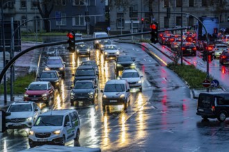 Rainy weather, road traffic, intersection, lights of vehicles on a wet road, traffic lights, tail