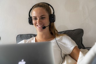 Young student learns at home, online, in conversation with other students