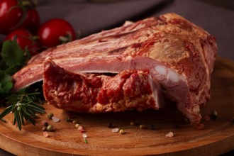 Smoked pork ribs, on a wooden table, top view, sauce, tomatoes and spices, close-up, vertical, no