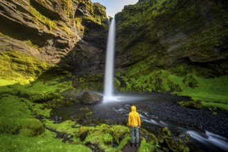 Tourist at Kvernufoss waterfall, in summer when the weather is nice, gorge and river, long