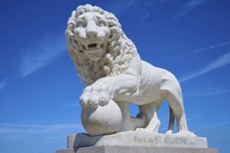 An impressive lion statue on a pedestal, on the Bridge of Lions, St Augustine, harbour, Matanzas