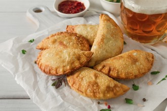 Fried chebureks, close-up, on a light background, no people