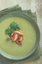 Pea cream soup, with shrimp, green soup, homemade, top view, no people