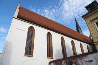 Church with red tiled roof and Gothic windows under a blue sky, St Augustin's Monastery Church,