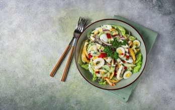 Salad with squid, fresh cucumber, eggs, sweet pepper, red onion, with dressing, homemade, no people