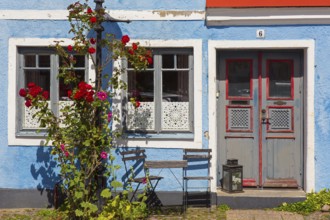 Façade of traditional house in blue pastel colour in the town Ystad in summer, Skåne, Scania,