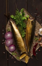 Smoked mackerel, top view, with spices, on a wooden table, no people, selective focus