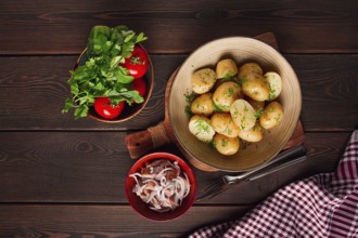 Fresh Cooked, new potatoes, with dill, on a wooden table, selective focus. close-up, toning, no