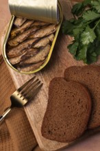 Preserves, sprats with black bread, top view, no people