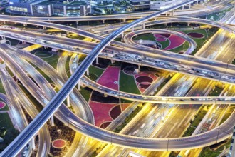 Intersection of Sheikh Zayed Road traffic on the road near the Burj Khalifa with Metro in Dubai,