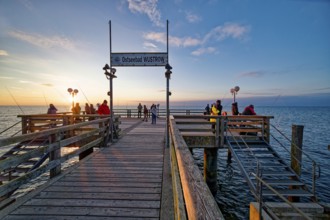 Baltic Sea beach, Baltic Sea coast Anglers on the Wustrow pier, evening mood, Baltic seaside resort