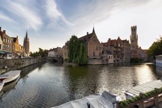 Guild houses on Rosenkranzkai or Rozenhoedkaai with canal, bell tower, historic centre, UNESCO