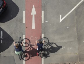 Cyclist casts a long shadow, travelling on a red-marked cycle path. Miltenberg, Lower Franconia,