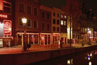 Night shot of the Oudezijds Achterburgwal in the red light district in Amsterdam, North Holland,