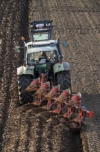 Farmer ploughing a field, tractor with plough, near Neuss, North Rhine-Westphalia, Germany, Europe