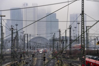 Railway tracks with regional and long-distance trains, ICE, after freezing rain, in front of