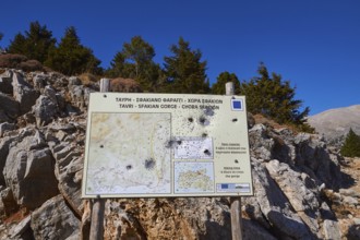 Niatos Plateau, information map on a signpost in a mountainous landscape by daylight, near Askifou,