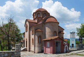 Traditional church with domed roof and red accents under a cloudy sky, Church of Panagia Gomatiou,